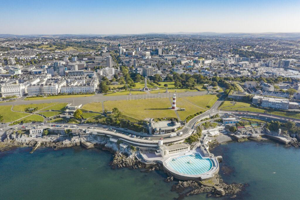 An aerial shot of Plymouth's coatline showing the Tinside Lido and Smeaton's Tower.