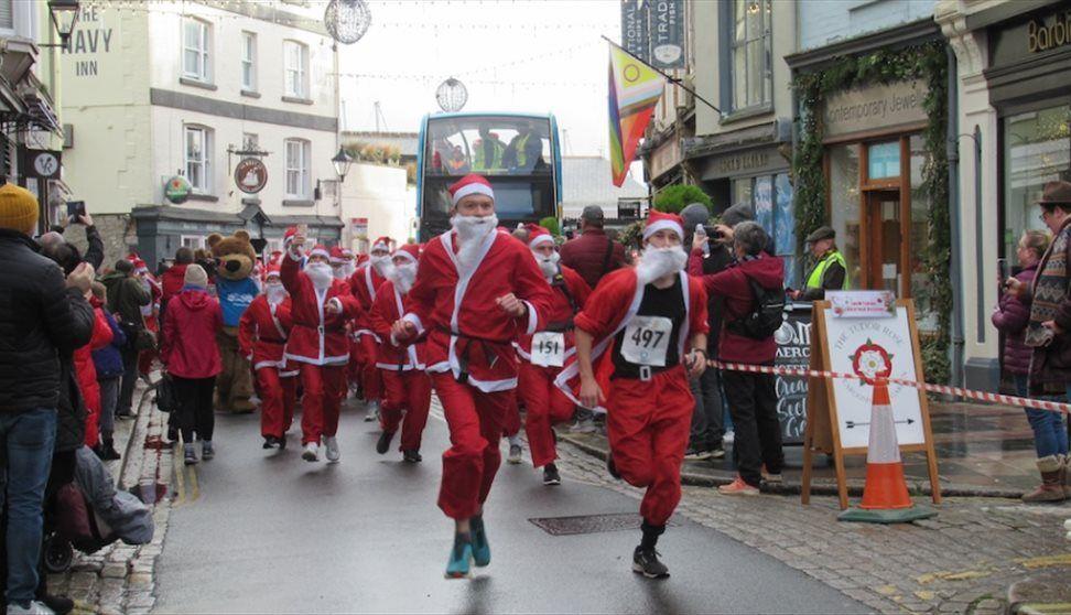 People dressed up as santa run through Plymouth's barbican