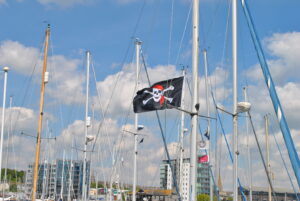 An image of a skull and crossbones flag flying on a boat mast in Sutton Harbour